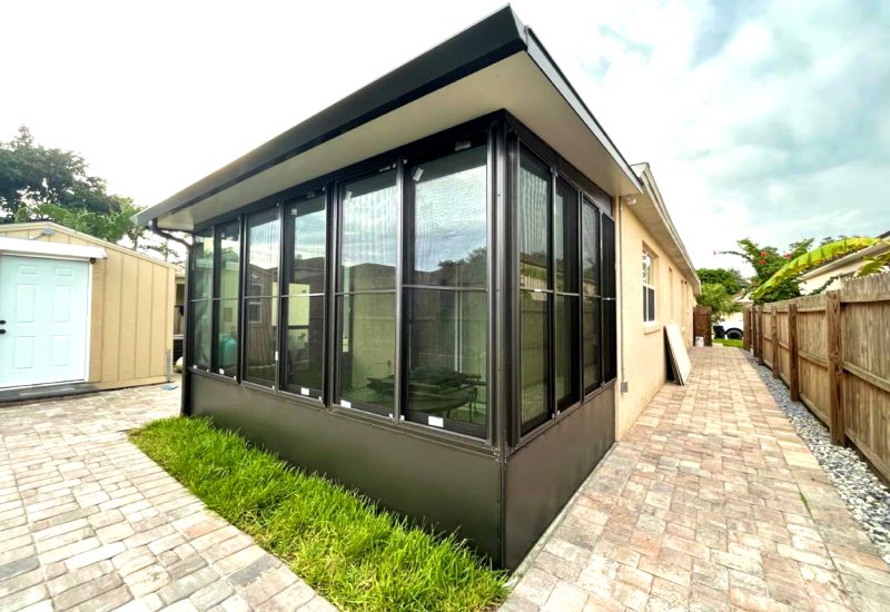 Workers Installing a Cozy Sunroom to Improve a House in Lake Nona, FL